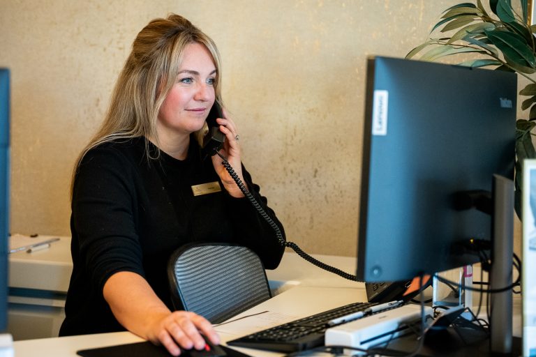 Dental nurse using the telephone to book an appointment