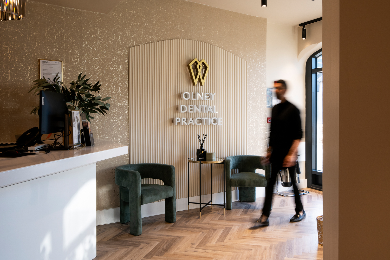 Person walking quickly through the reception area at Olney Dental Practice