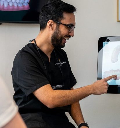 Dentist showing scans of teeth to his patient